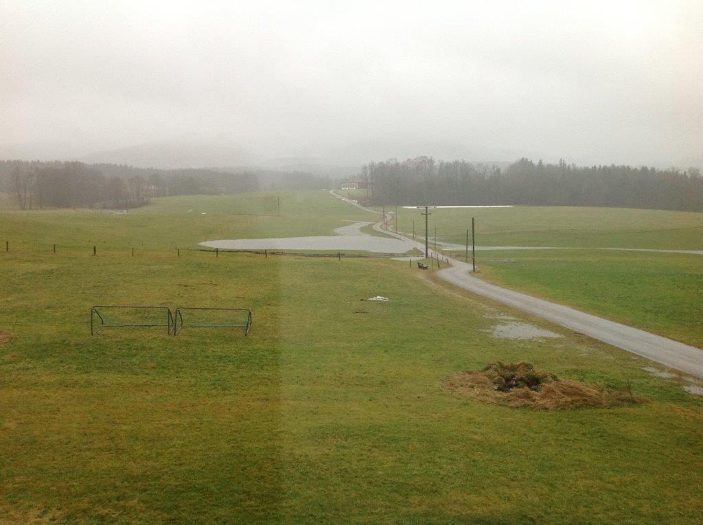 Waakirchen Hörpointer Weg: Blick nach Süden nach Regen - links und rechts der Straße haben sich Bachläufe gebildet
